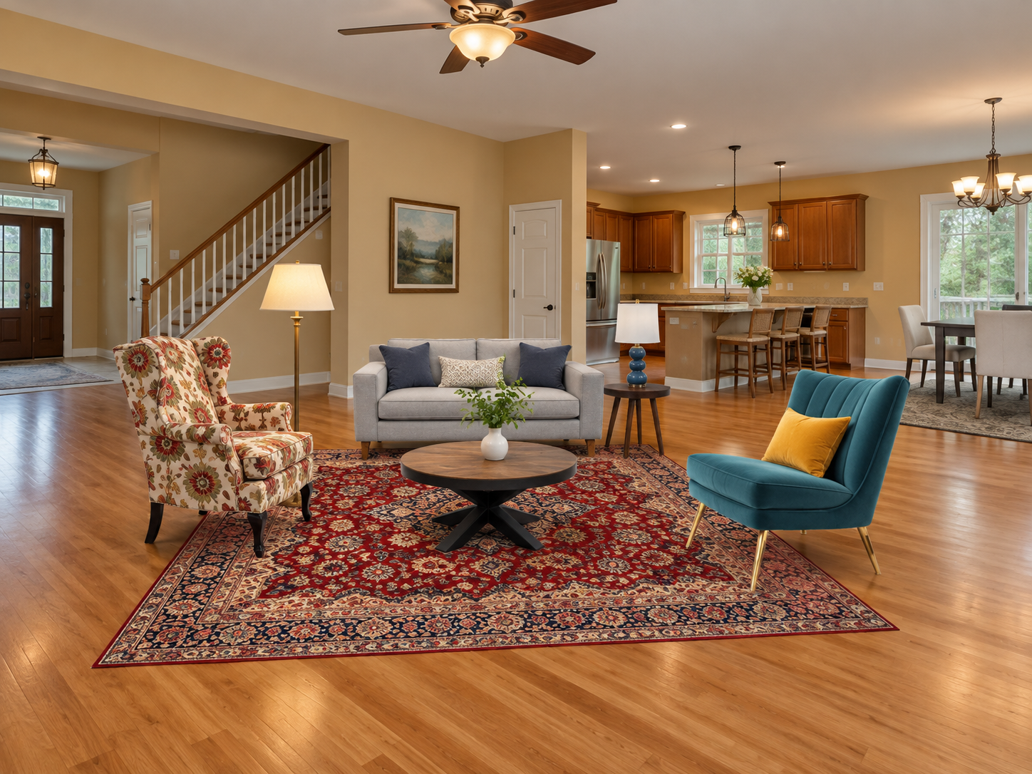 Virtually staged open-concept living room with a floral armchair, small gray sofa and brightly colored accent chairs